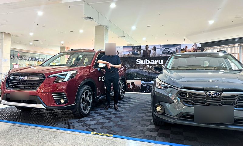 The Forester and the Crosstrek from a closer angle, the ULTRAGRID Space Grey floor and ULTRAEDGE Riviera Blue edge in the foreground