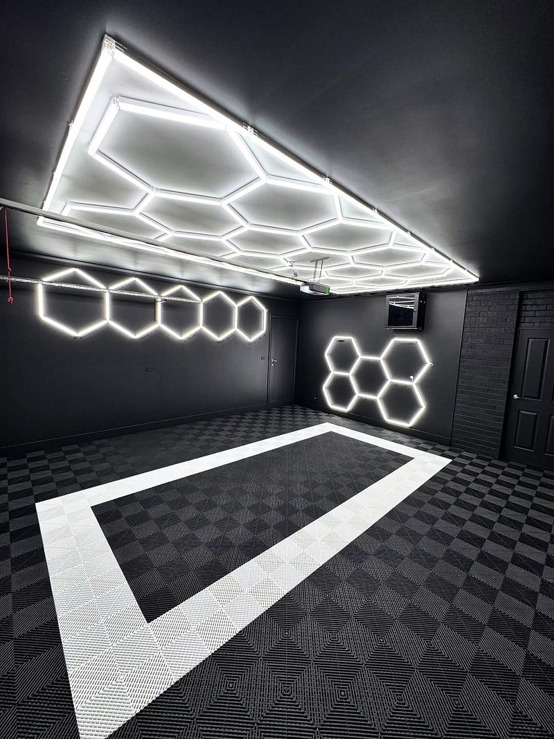 The Alpine White outline seen from a corner on the Jet Black ULTRAGRID chequer, black walls and ceiling