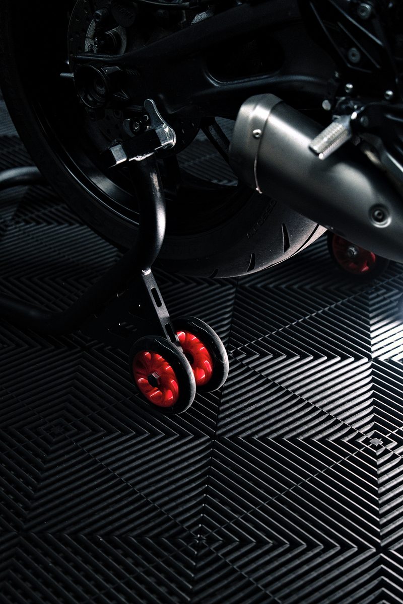 A bike stand and wheel resting on the Jet Black ULTRAGRID tiles