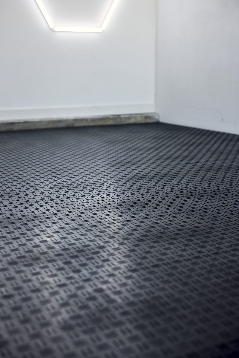 Low angle across the ULTRATUFF Space Grey floor with a hexagon light glowing at the top of the frame
