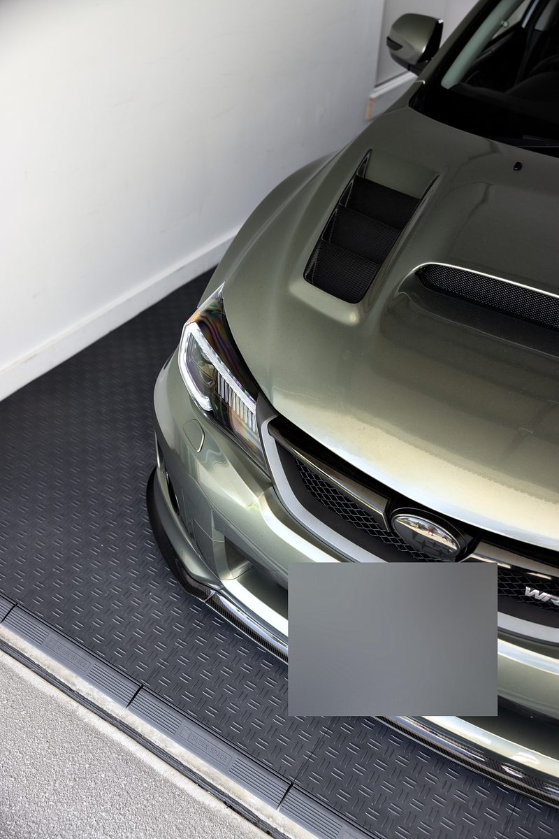 Close on the Subaru's bonnet and front corner beside the ULTRATUFF Space Grey floor