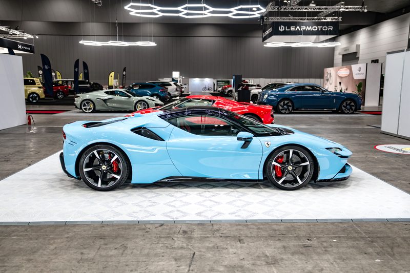 Ferrari SF90 on ULTRACORE Alpine White tiles under ULTRABEAM hexagon lights at the Melbourne EV Show