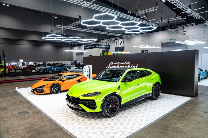 Lamborghini Urus and Lamborghini Revuelto on ULTRAFLUX Alpine White tiles under ULTRABEAM hexagon lights